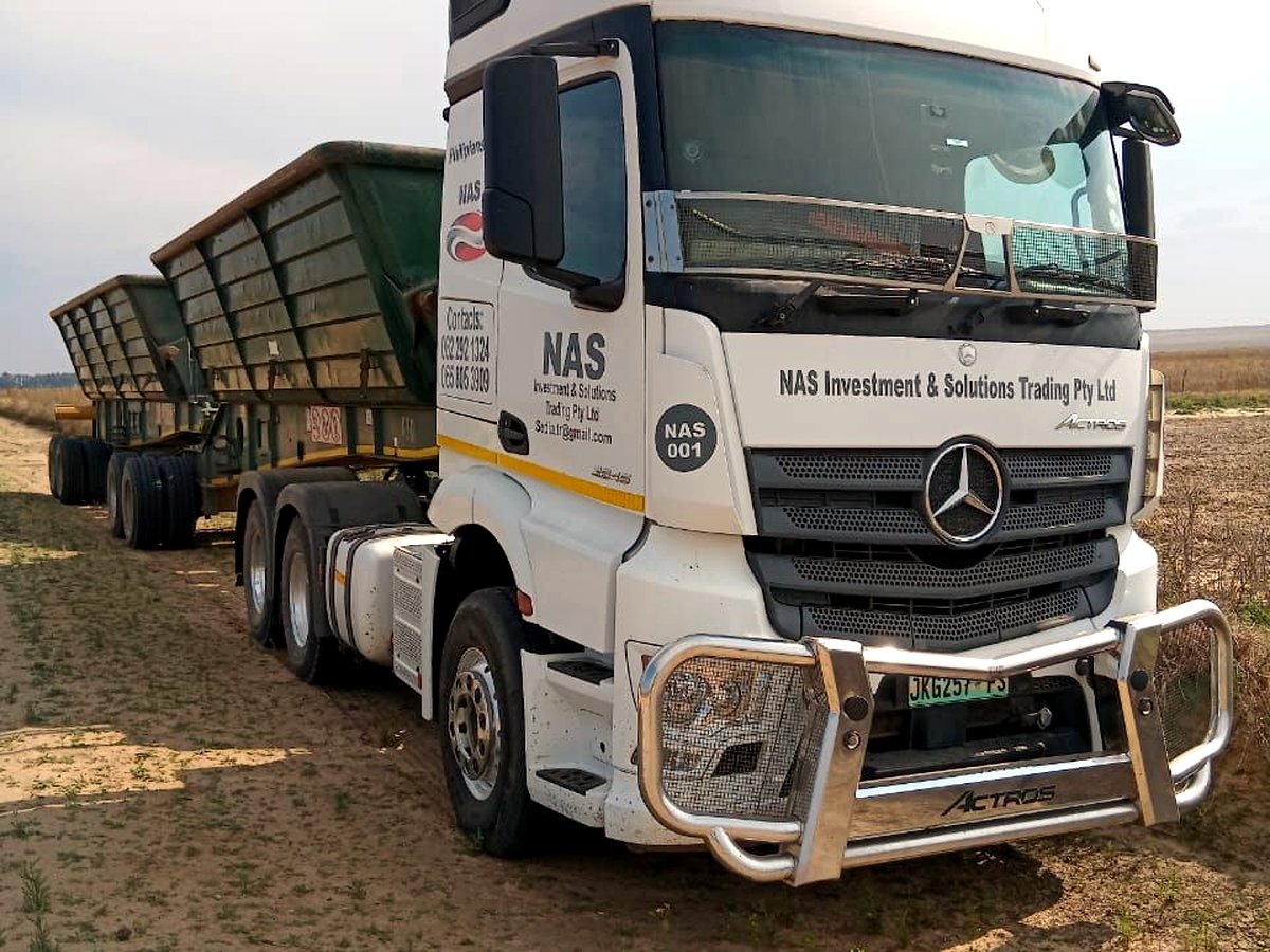 NAS Investment & Solution Trading branded Mercedes-Benz Actros with side-tipper trailers on site